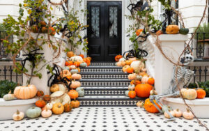 Pumpkin delivery service Grande Harvest package with white and orange pumpkins, mums, and hay bales styled on elegant steps