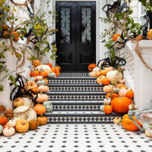 Pumpkin delivery service Grande Harvest package with white and orange pumpkins, mums, and hay bales styled on elegant steps