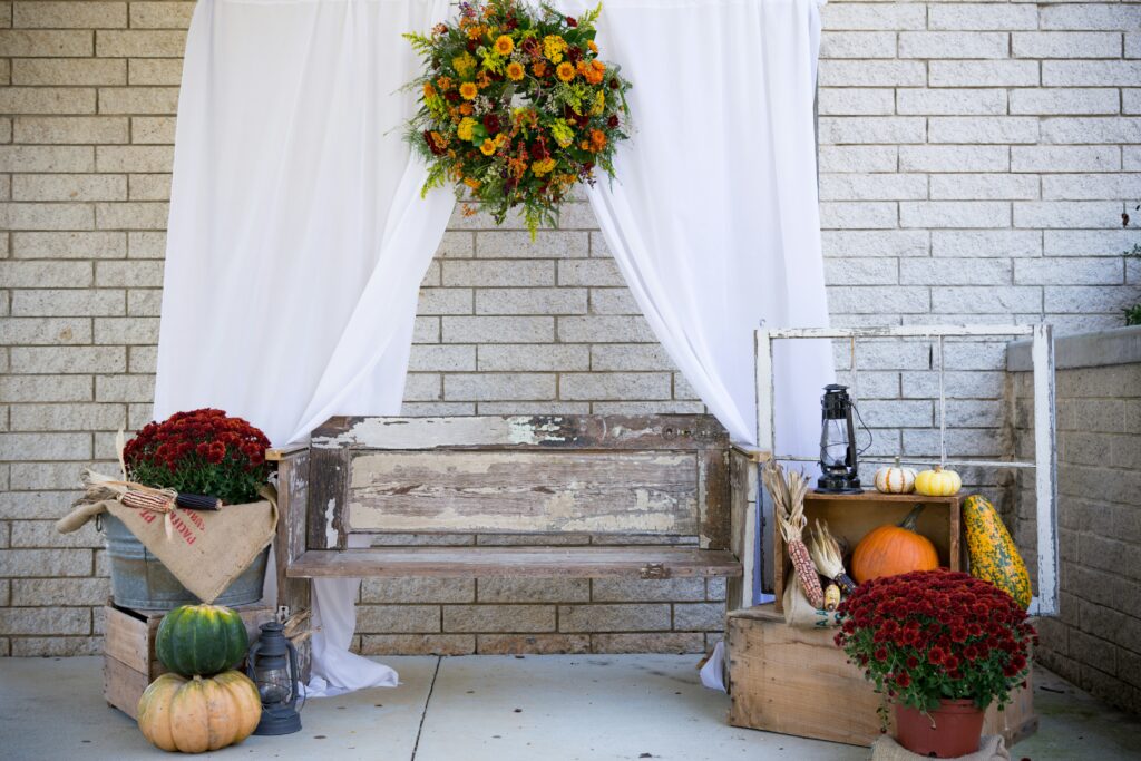 Seasonal porch design blog with fall bench display, pumpkins, and wreath