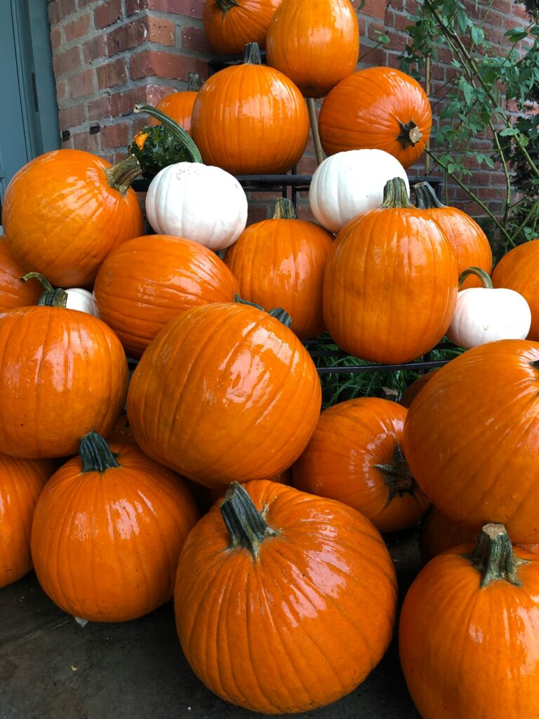 Stack of bright orange pumpkins perfect for porch pumpkin decor ideas