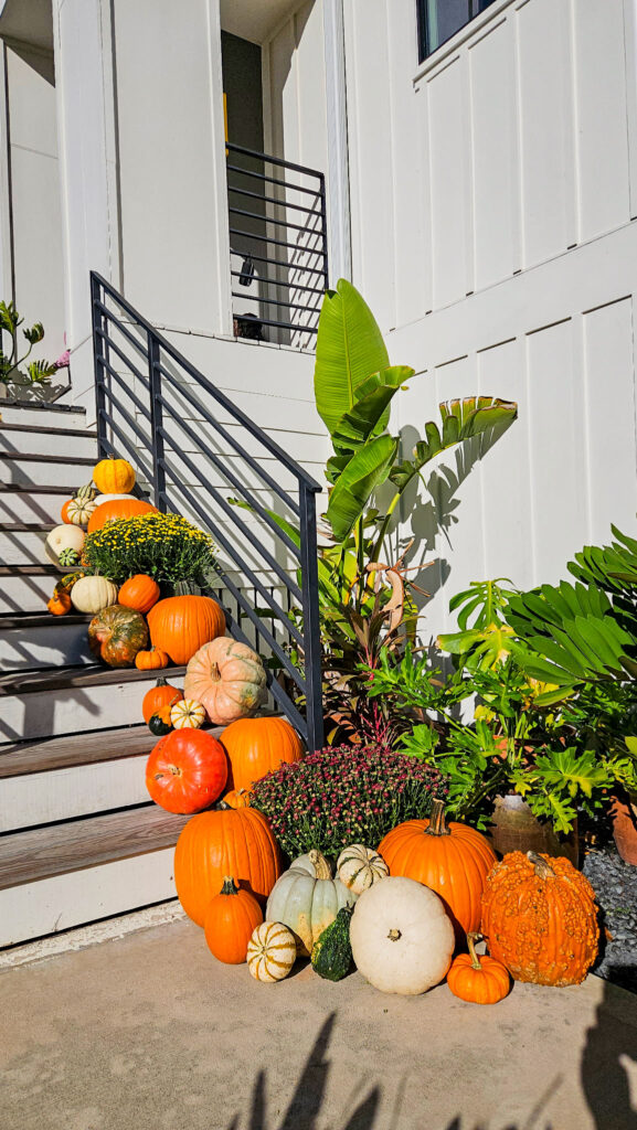 pumpkin decoration ideas for fall porch with stacked pumpkins on stairs
